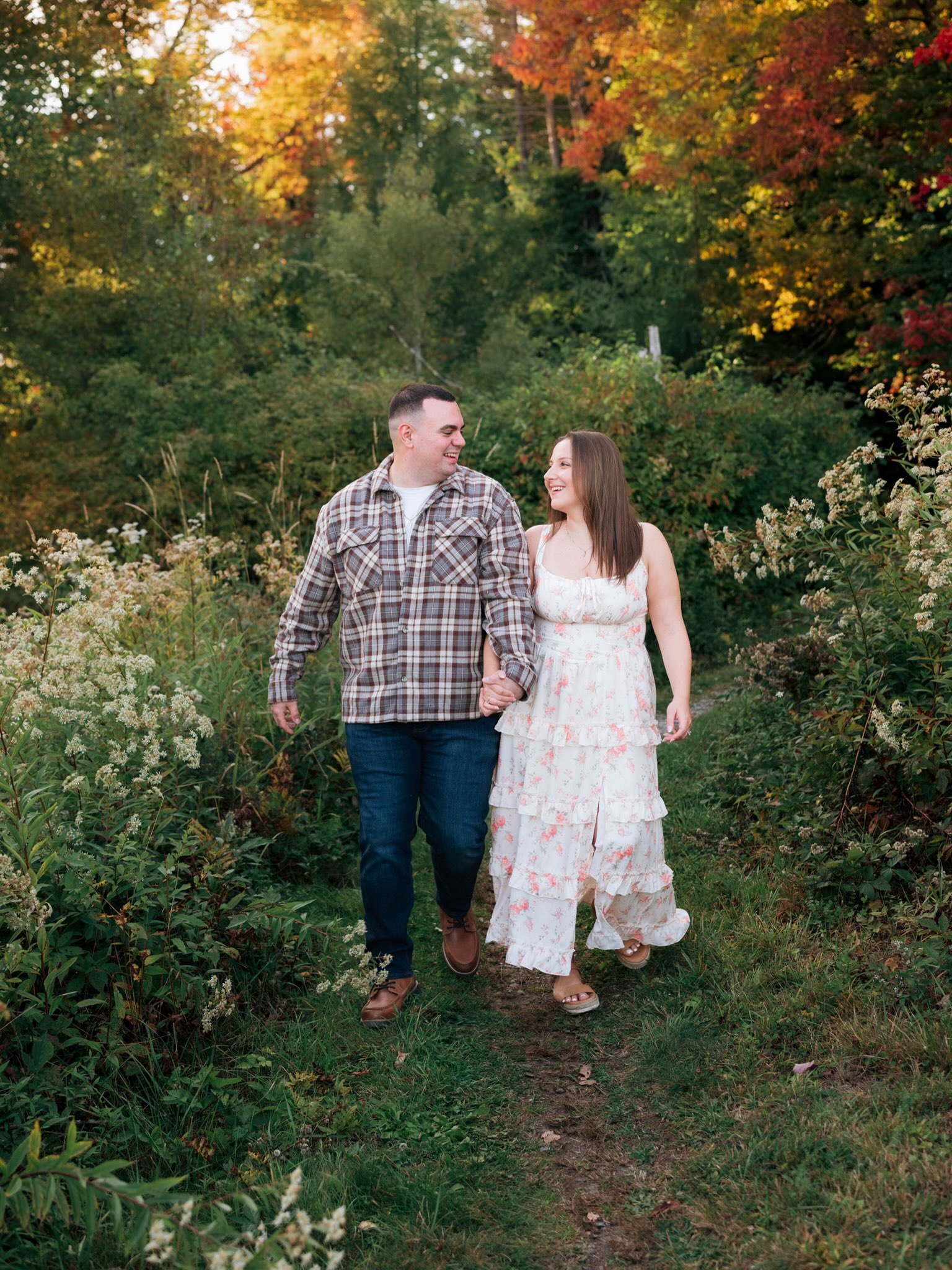 John and Erica walking together along a garden path