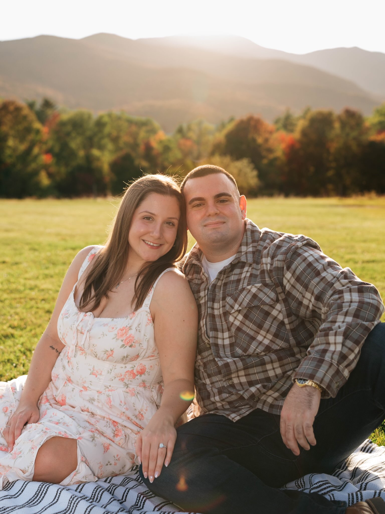 John and Erica sitting together on a picnic blanket