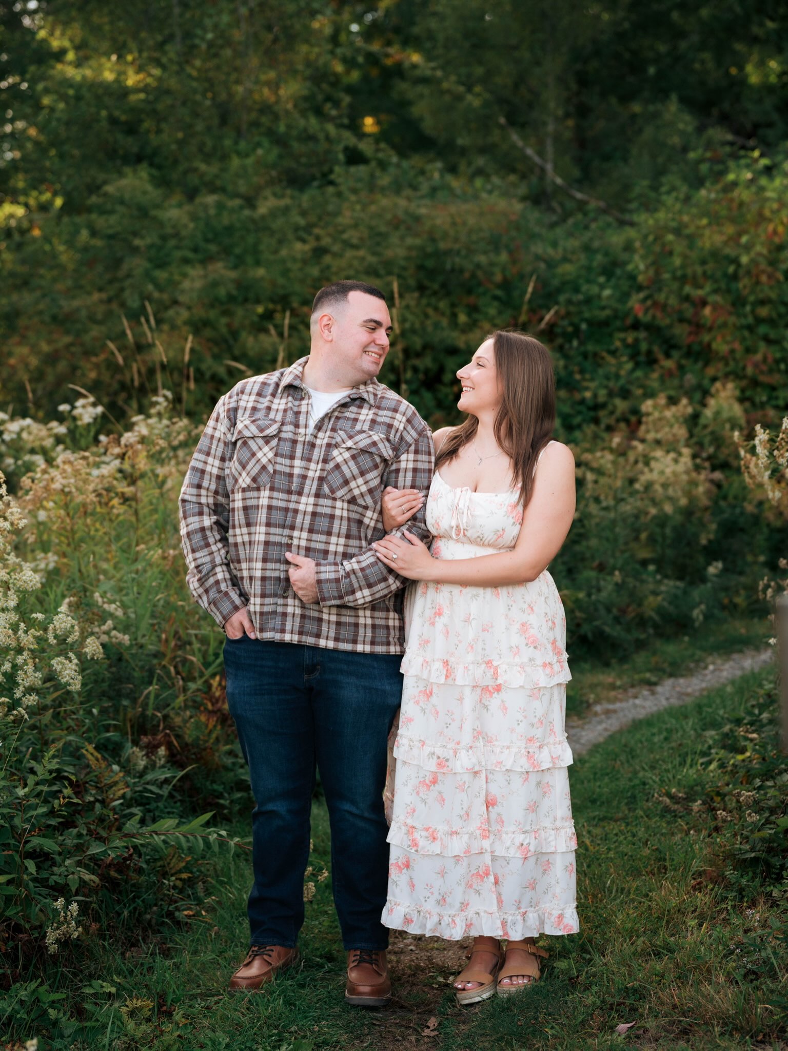 John and Erica holding each other beside the garden path