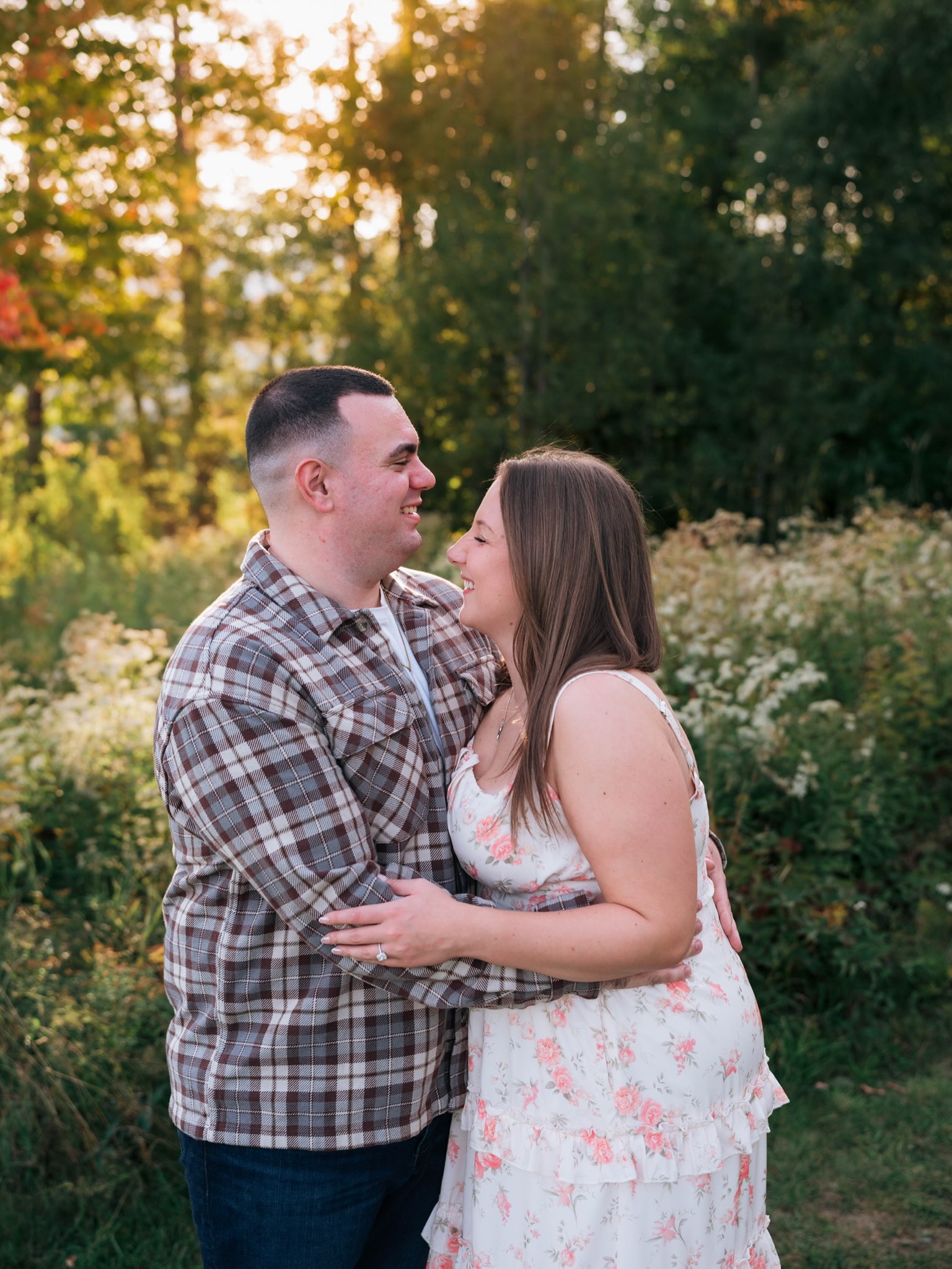 John and Erica smiling at each other in the autumn light