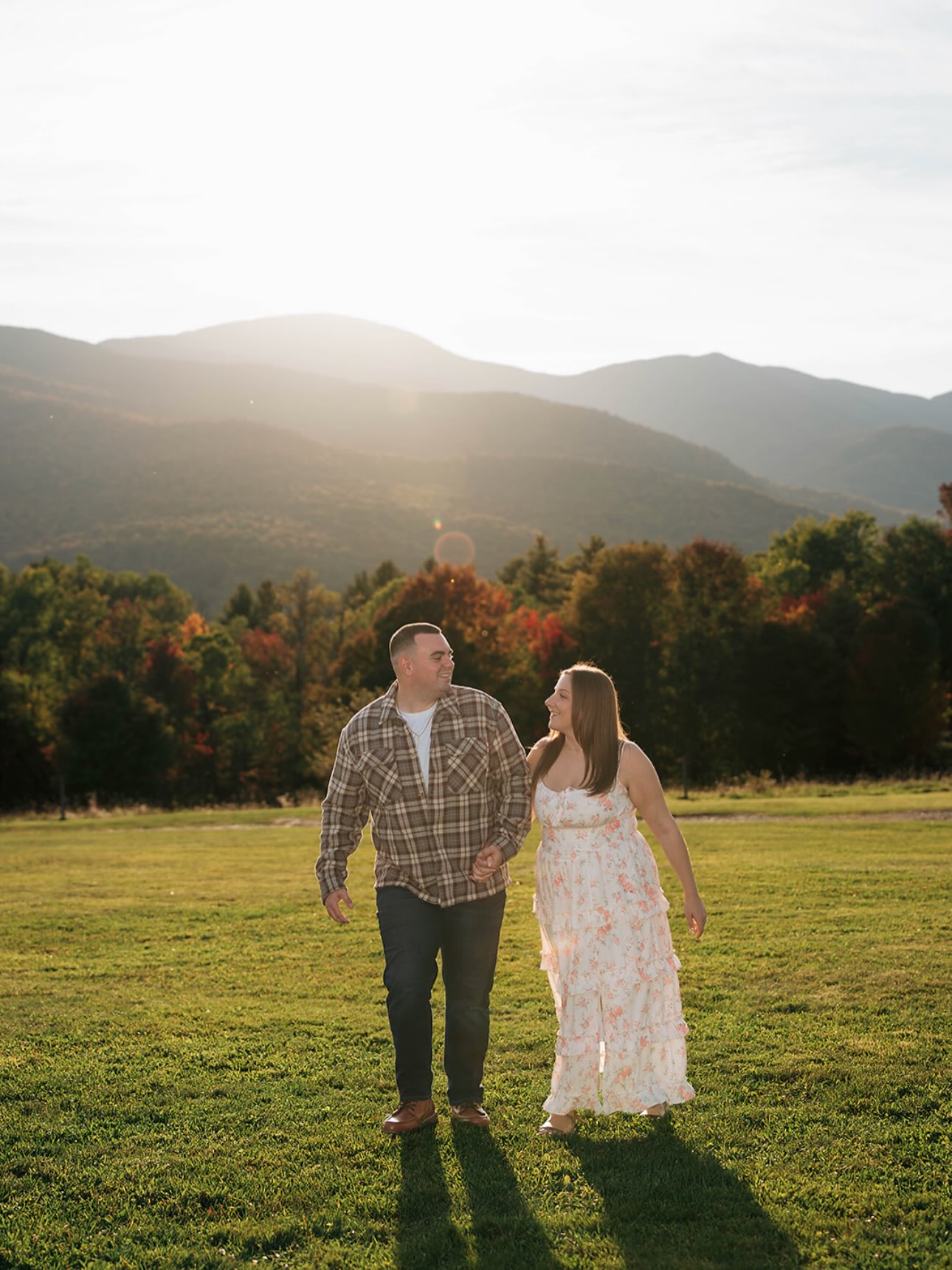 John and Erica walking hand in hand toward the mountains